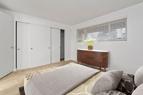Everett apartment for rent - a bedroom with a bed and a dresser and a window