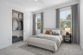 Las Vegas townhouse for rent - A bedroom with a large bed and a window with curtains.