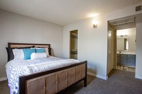 Tucson apartment for rent - 1-Bedroom Apartments in Tucson, AZ - Peaks at Redington - Bedroom with Carpeted Floor, Full-Size Bed, Spacious Closet with Clothes Hangers, and Attached Bathroom.