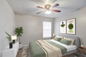 Kansas City apartment for rent - an empty bedroom with a bed and a ceiling fan