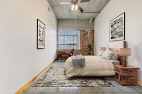St. Louis apartment for rent - A bedroom with a large bed and a rug on the floor.