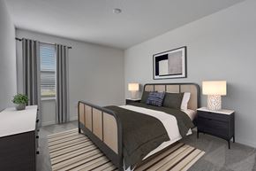 Kissimmee townhouse for rent - A bedroom with a bed, nightstand, and a plant.