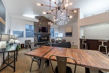 Kent apartment for rent - a dining room table and living room with a fireplace