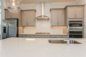 Sandy Springs triplex for rent - A modern kitchen with a stainless steel refrigerator and a white countertop.