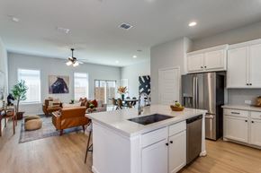 Fate apartment for rent - A modern kitchen with a large island and stainless steel appliances.