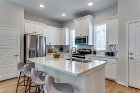 Fate apartment for rent - Fate, TX, Apartments - Canopy at Woodcreek - Kitchen with Quartz and Marble Countertops with Ceramic Tile Backsplash, Farmhouse Sink, and Stainless Steel Appliances