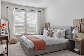 Denver apartment for rent - a bedroom with a bed and a large window