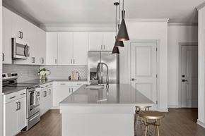 Denver apartment for rent - a kitchen with white cabinets and stainless steel appliances