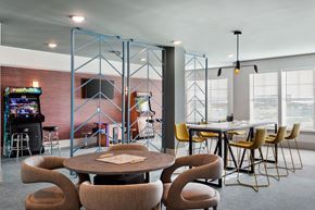 Denver apartment for rent - a dining room with a table and chairs and a video game