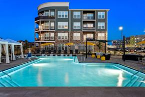 Denver apartment for rent - a swimming pool at night with a building in the background
