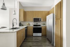 Las Vegas apartment for rent - A modern kitchen with wooden cabinets and stainless steel appliances.