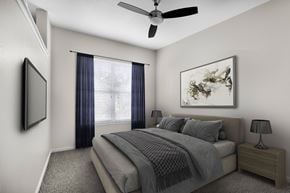 Las Vegas apartment for rent - A bedroom with a bed, nightstand, and a ceiling fan.