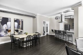 Las Vegas apartment for rent - A dining room with a white table and black chairs.