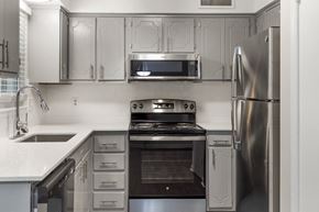 Raleigh apartment for rent - a kitchen with stainless steel appliances and white cabinets