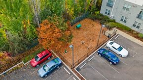 Sherwood apartment for rent - A parking lot with cars and a playground.