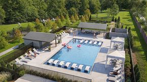 Fate apartment for rent - One-Bedroom Apartments in Fate, TX - Canopy at Woodcreek - Resort-Inspired Pool with Sundeck and Cabanas, Lounge Chairs in the Water, and Tanning Chairs.