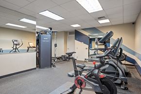 Spokane apartment for rent - A gym with a row of stationary bikes and a treadmill.
