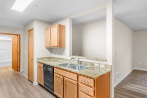 Spokane apartment for rent - A kitchen with wooden cabinets and a granite countertop.