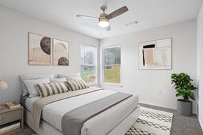 Little Rock apartment for rent - Pet-Friendly Rentals in Little Rock, AR – Capitol Hill – A bedroom with a large bed and a ceiling fan.