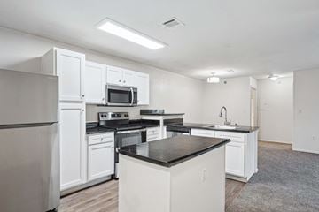 Little Rock apartment for rent - A kitchen with white cabinets and appliances.