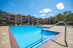 Little Rock apartment for rent - Pet-Friendly Rentals in Little Rock, AR – Capitol Hill – Swimming pool with the apartment complex in the background