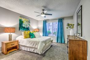 Las Vegas apartment for rent - A bedroom with a bed, nightstand, and a painting on the wall.