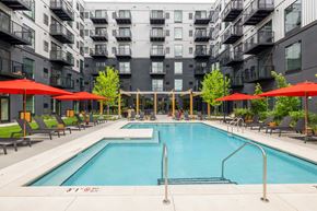 Bloomington apartment for rent - a swimming pool in front of an apartment building
