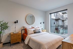 Bloomington apartment for rent - a bedroom with a bed and a large window