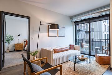 Bloomington apartment for rent - a living room with a couch and a glass table