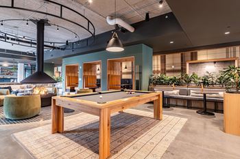 Modern clubroom with indoor fireplace, cozy booths and pool table