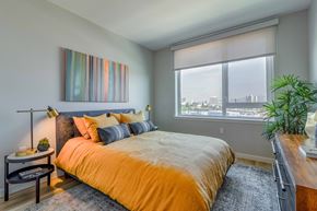 Oakland apartment for rent - a bedroom with a large bed and a window