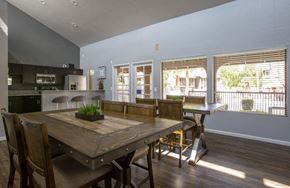 Tucson apartment for rent - a large dining room with a wooden table and chairs