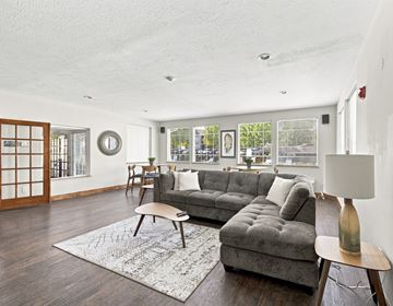 Spokane apartment for rent - A living room with a grey couch and a wooden coffee table.