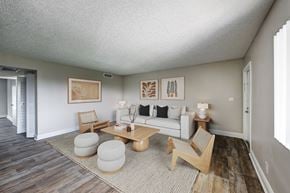 Palm Springs apartment for rent - Open living area with wood-style flooring and large windows at Coronado Springs Apartments in Palm Springs, FL. Pet-friendly one- and two-bedroom apartments for rent.