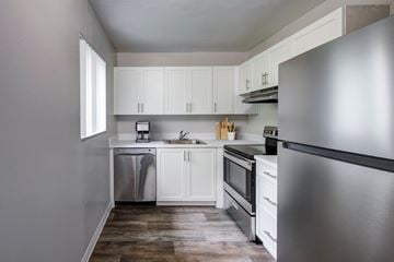 Palm Springs apartment for rent - A kitchen with white cabinets and stainless steel appliances.