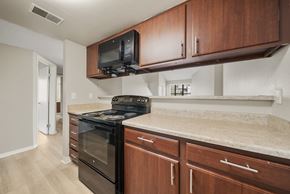 Aurora apartment for rent - A kitchen with a black oven and microwave above it.