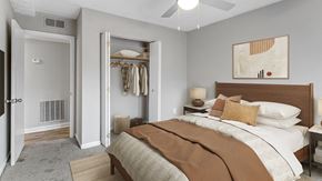 Norcross apartment for rent - Modern bedroom with plush bedding and walk-in closet at Elliot Norcross Norcross GA