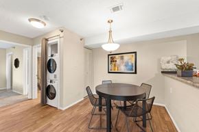 Olathe apartment for rent - A dining room with a round table and chairs.