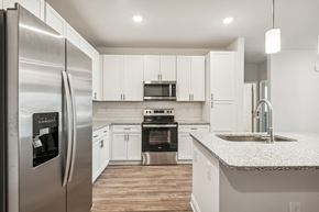 Travelers Rest apartment for rent - A modern kitchen with a stainless steel refrigerator and white cabinets.