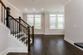 Sandy Springs triplex for rent - A spacious room with a staircase leading to the upper level.