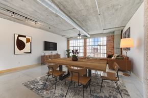 St. Louis apartment for rent - A dining room with a long wooden table and chairs.