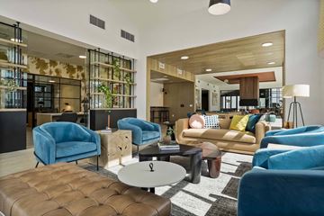 Denver apartment for rent - a living room with blue chairs and couches