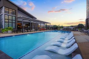 Denver apartment for rent - A long rectangular pool with white steps leading into it.