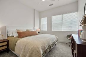 Denver apartment for rent - Denver, CO Apartments Near Target - Edera Apartments - Bedroom With Plush Carpet Flooring, a Ceiling Fan, and Large Windows