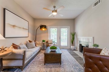 Cordova apartment for rent - A living room with a white couch, a coffee table, and a painting on the wall.