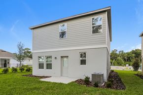 Deland townhouse for rent - A two-story house with a grey exterior and a white door.