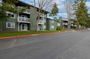 Lynnwood apartment for rent - Apartments For Rent In Lynnwood - Evergreen Grove Apartments - Building Exterior With Parking Lot Access, Private Patios, And Tall Trees