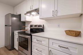 Lynnwood apartment for rent - a kitchen with white cabinets and stainless steel appliances