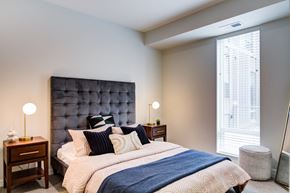 Bloomington apartment for rent - A bedroom with a large bed and a blue headboard.