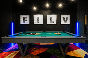 Las Vegas apartment for rent - A pool table with a green felt cloth and white cue ball and red and white balls on it.